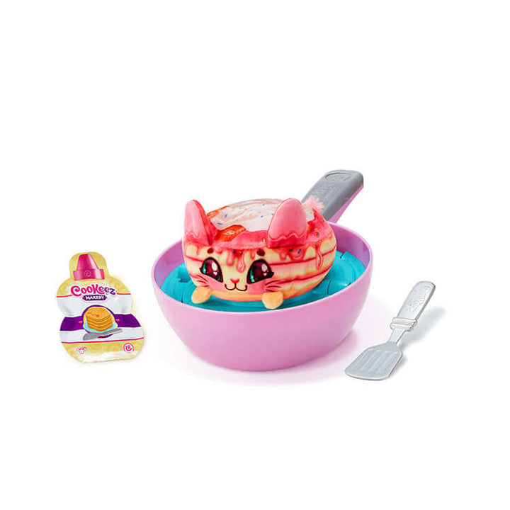 Cookeez Makery Pancake Treatz Playset with plush pancake toy, mixing bowl, spatula, and batter pack for interactive play.