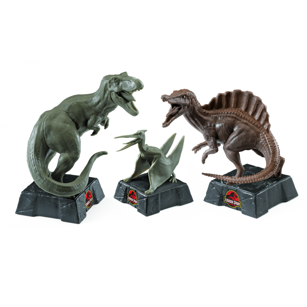 Jurassic Park Chess Set display featuring T-Rex, Spinosaurus, and Velociraptor dinosaur pieces.