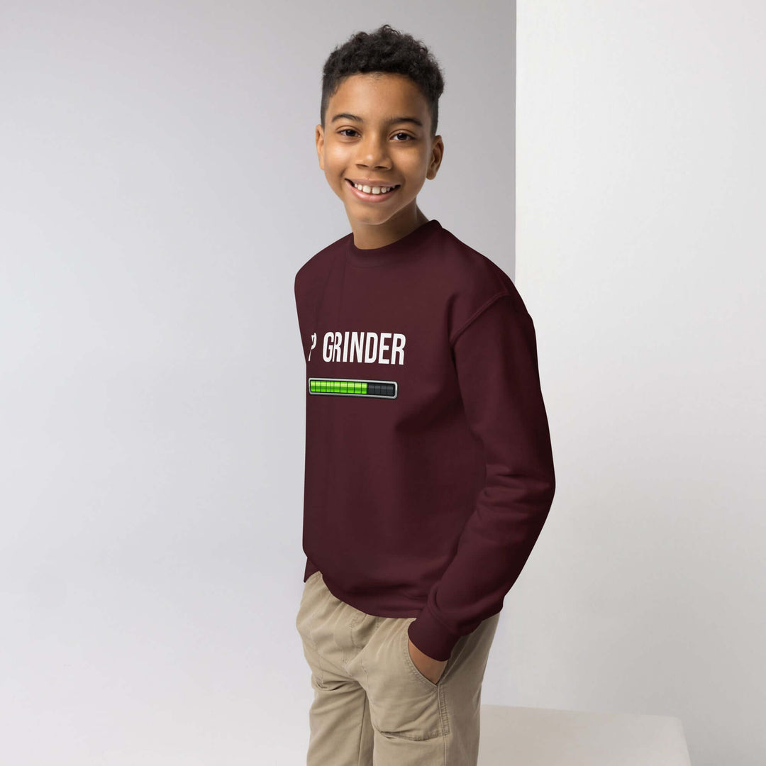 XP Grinder Youth crewneck sweatshirt worn by smiling boy, showcasing cozy design and fun graphic.