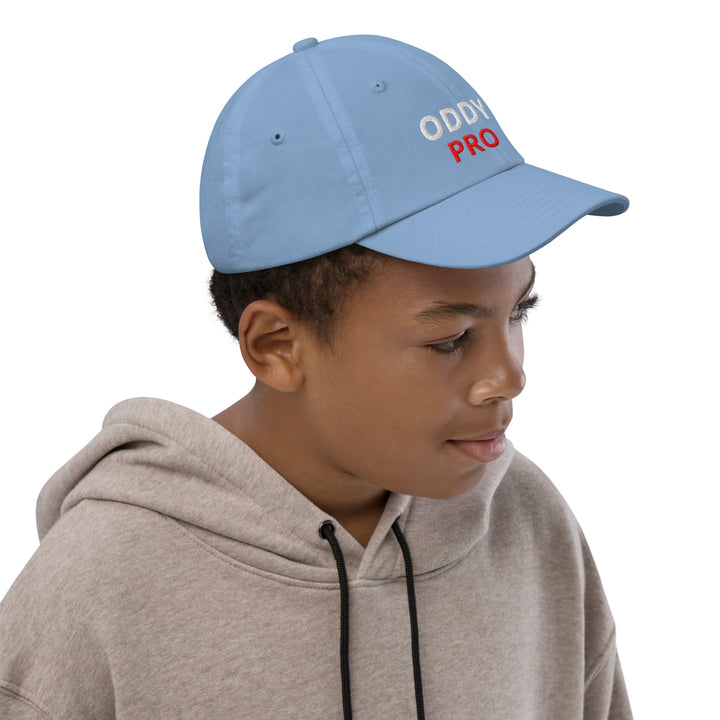 Oddy Pro Youth baseball cap in blue worn by a child, providing style and sun protection during outdoor activities.