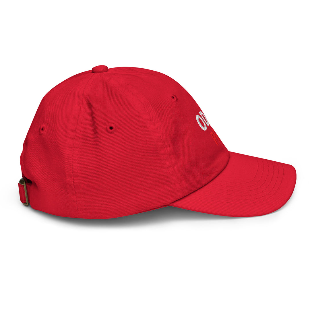 Oddy Pro Youth baseball cap in red, featuring six eyelets and an adjustable strap for a comfortable fit.
